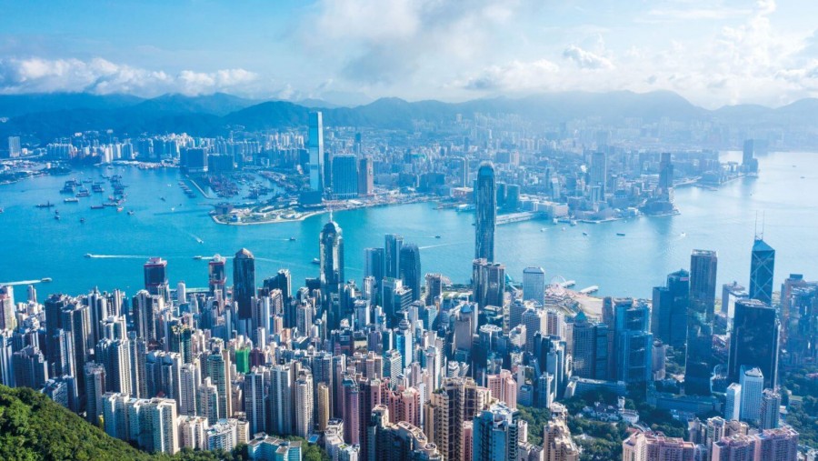 Victoria Harbor in Hong Kong as seen from Victoria Peak with Hong Kong Island Central District in the foreground, and Kowloon Peninsula in the background.