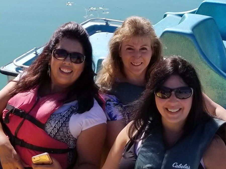 My friend (navy blue Cabela's life jacket), her friend (red life jacket), and I rented a paddle boat at Palisade Lake near Sterling, Utah in Aug 2019.